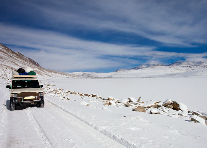 A Jeep Travelling on Snowy highway of Leh